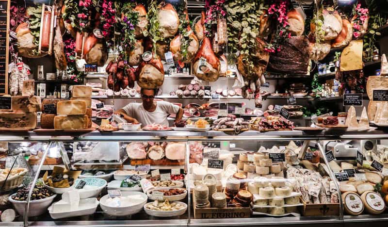 food market in Italy, with meats and cheeses.