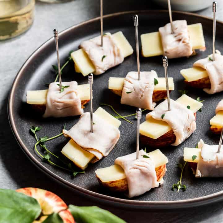 apples, cheese, and turkey bites on dark gray plate