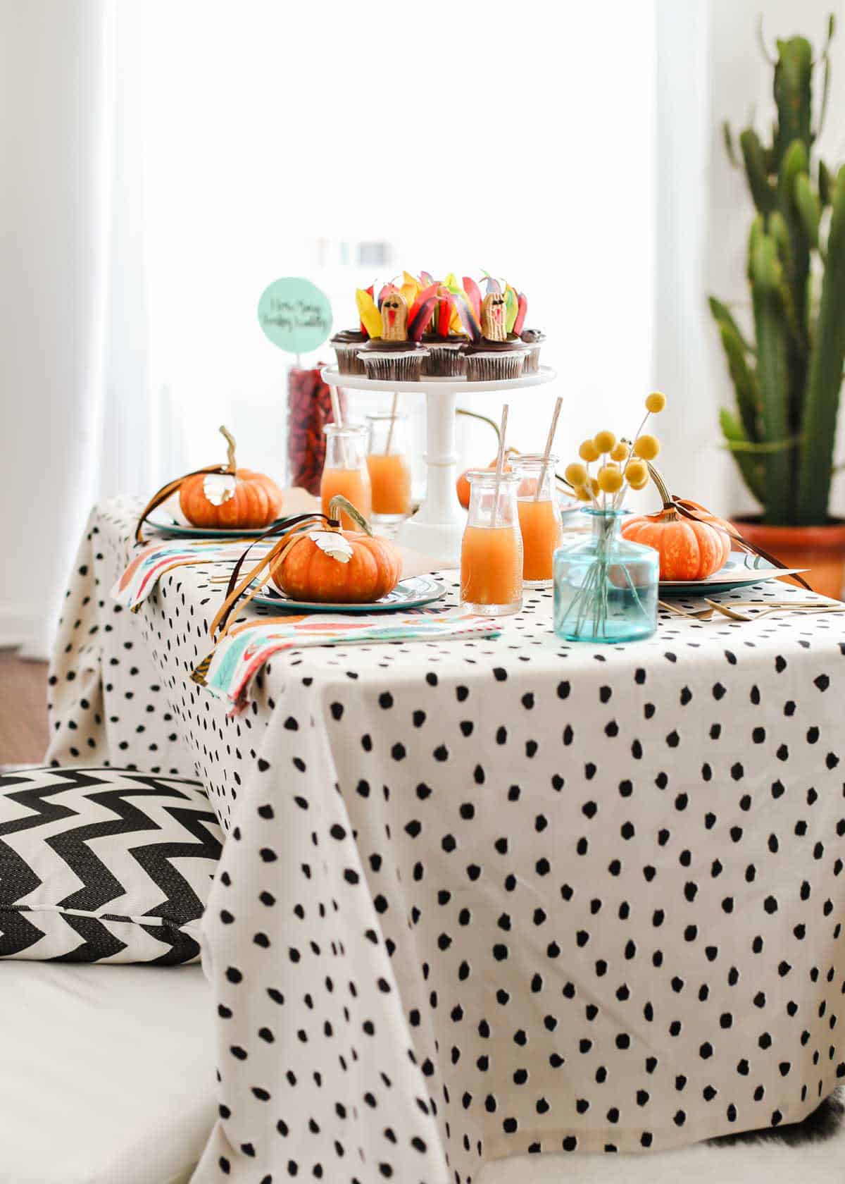 colorful kids table for Thanksgiving, with floor seating.