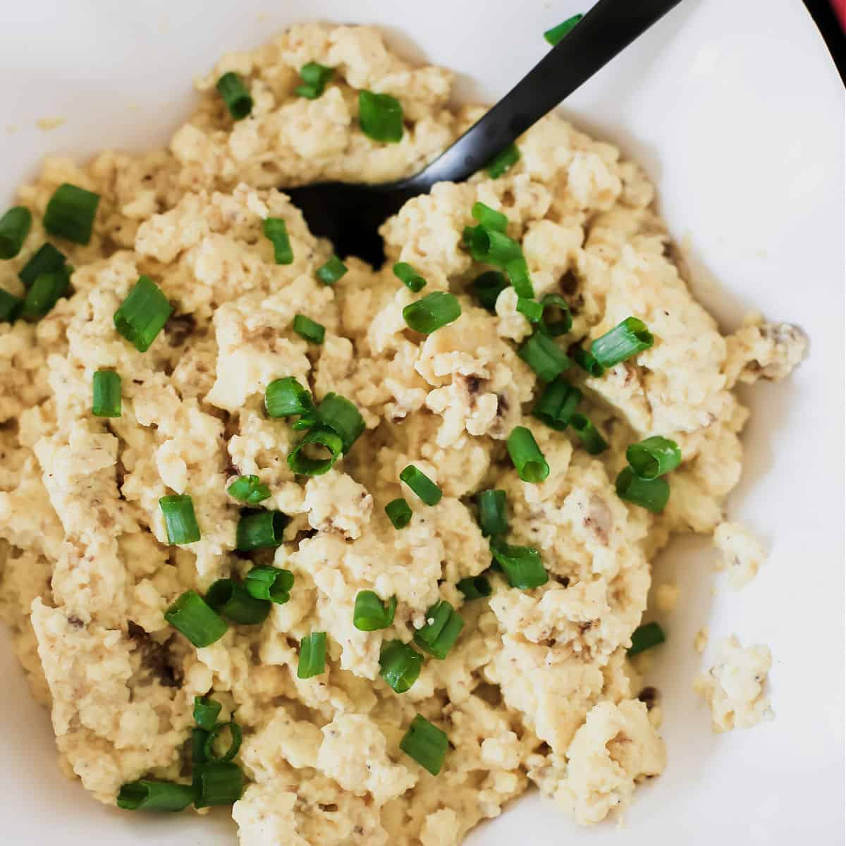 scrambled eggs brunch recipe with chives on top.