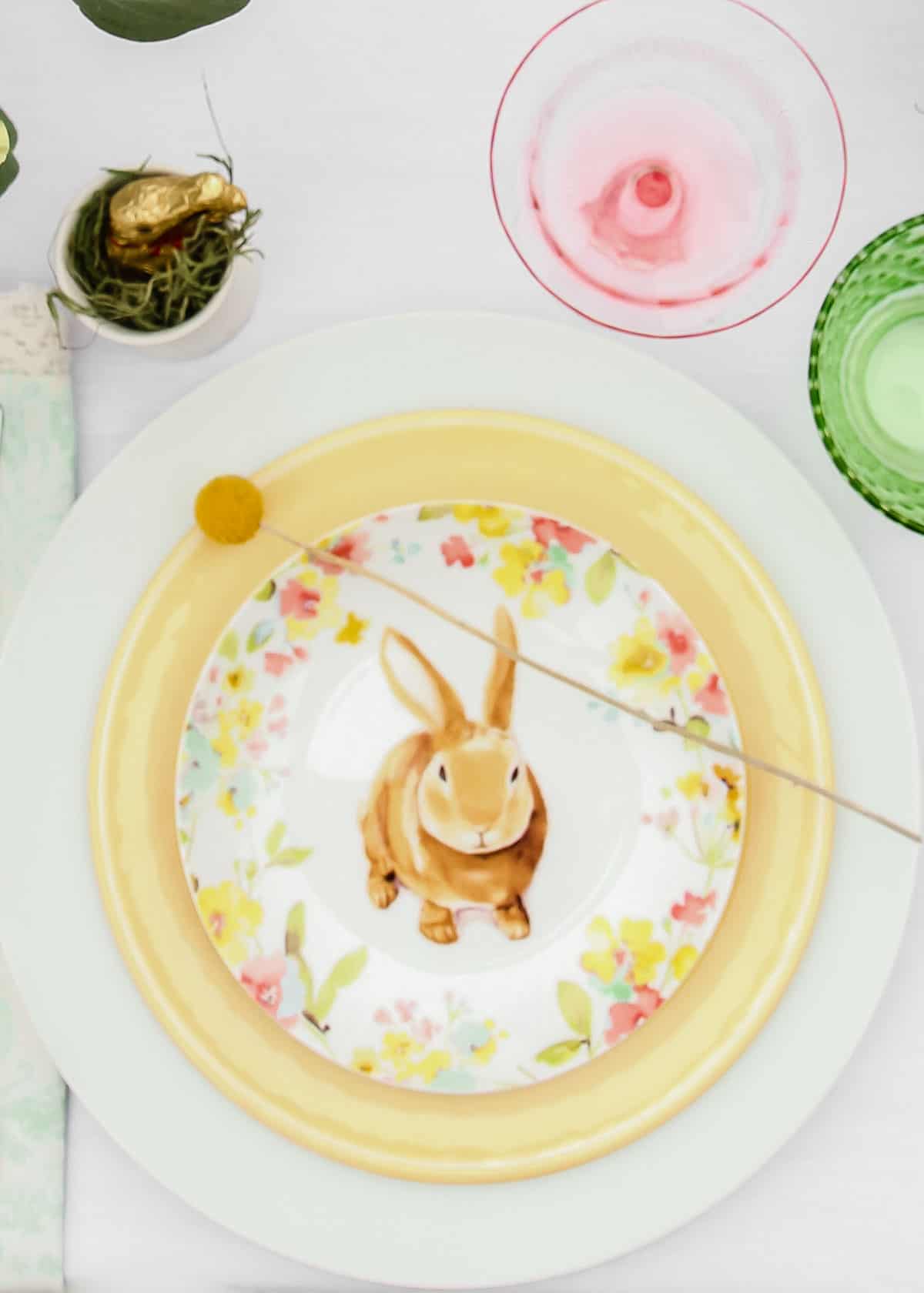 Easter place setting with Easter themed plate on top.