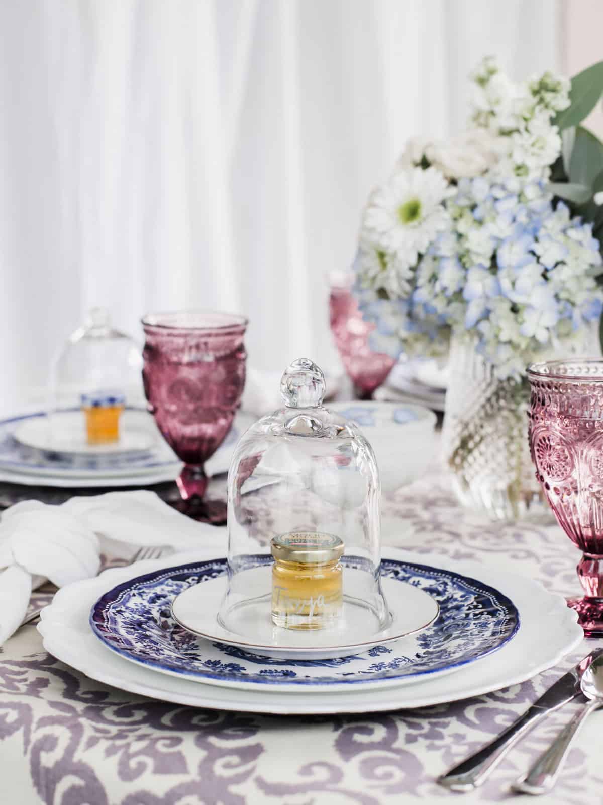 dining table set for ladies luncheon with blue and white place settings.