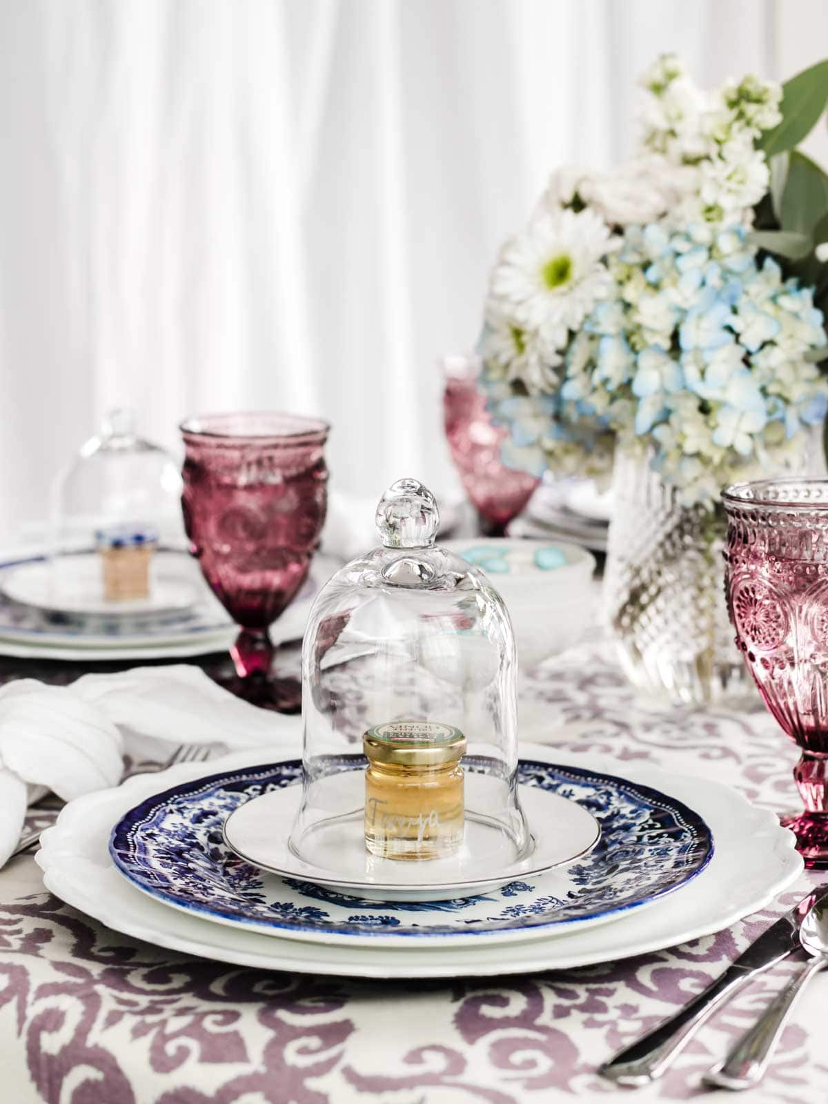 dining table set for ladies luncheon with blue and white place settings.