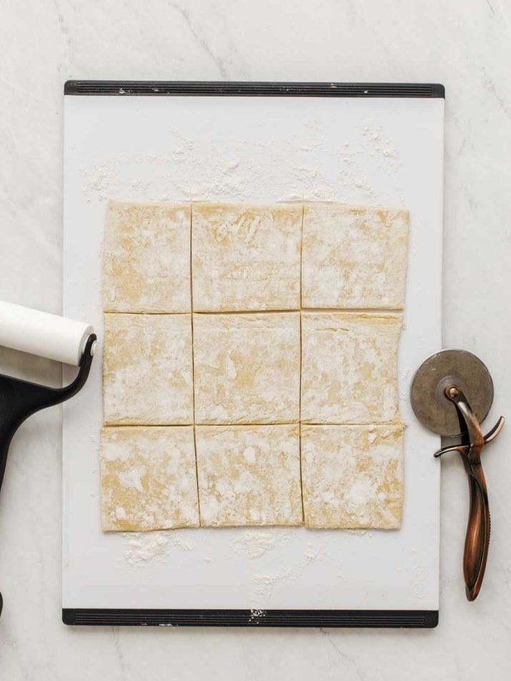 pastry dough on cutting board, cut into squares.