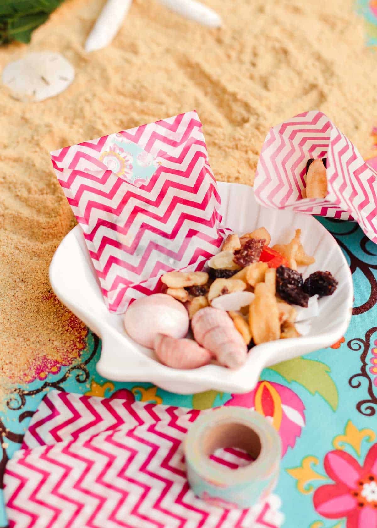 party display with sand and tropical trail mix in small bags.