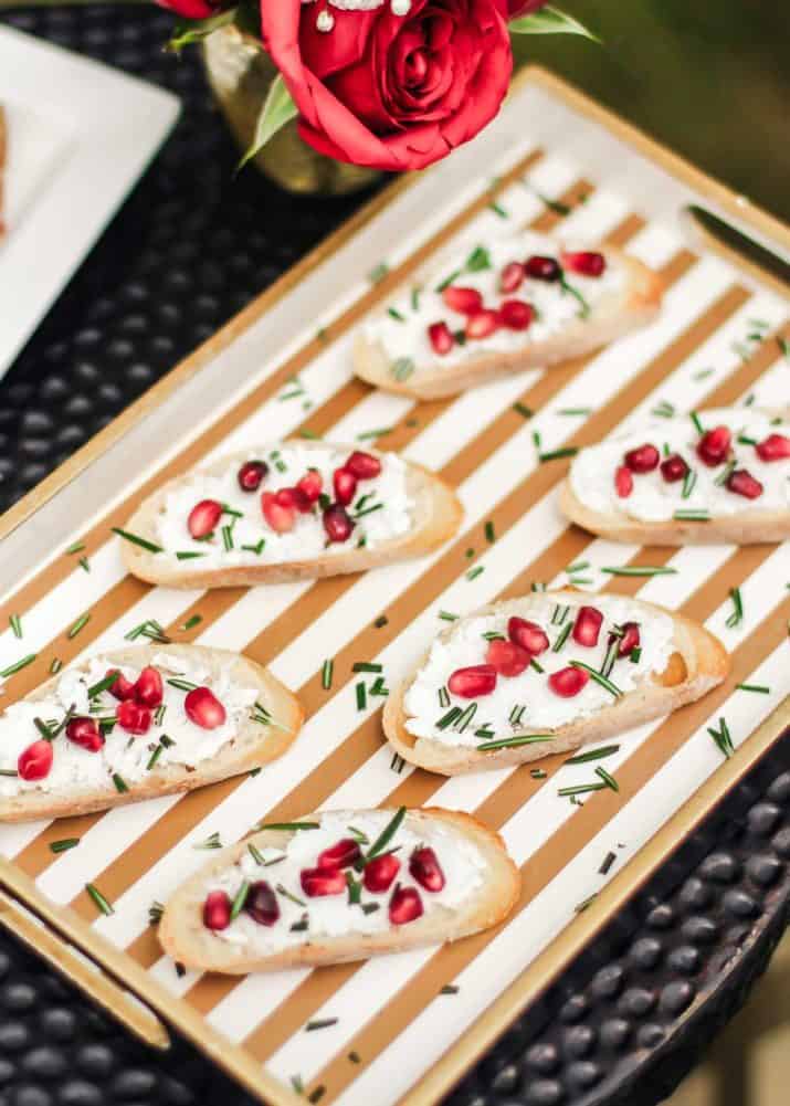 appetizer crostini with cream cheese and pomegranate arils.