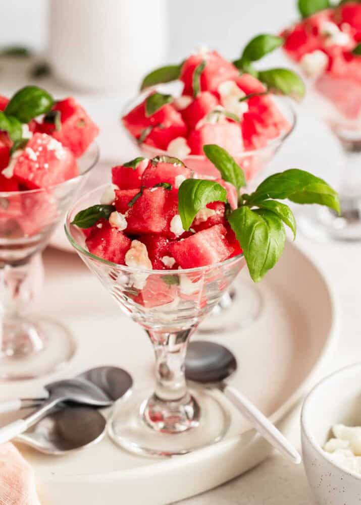 watermelon and feta salad in mini martini glasses on tray. 