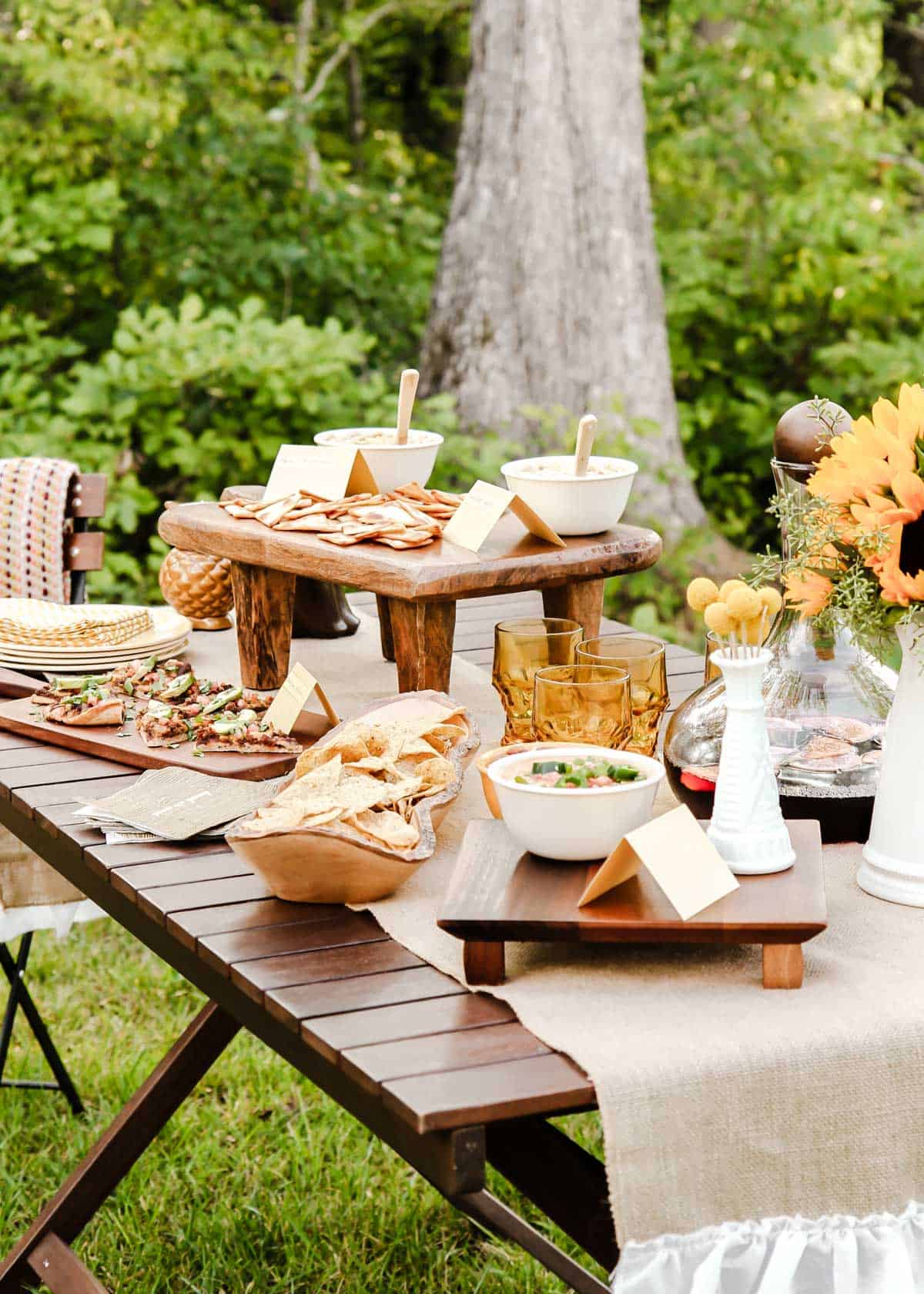 party table with food and drink set up outside.