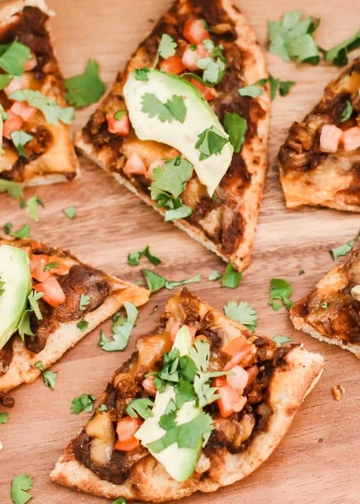 pizza triangles with black beans, tomato and avocado.