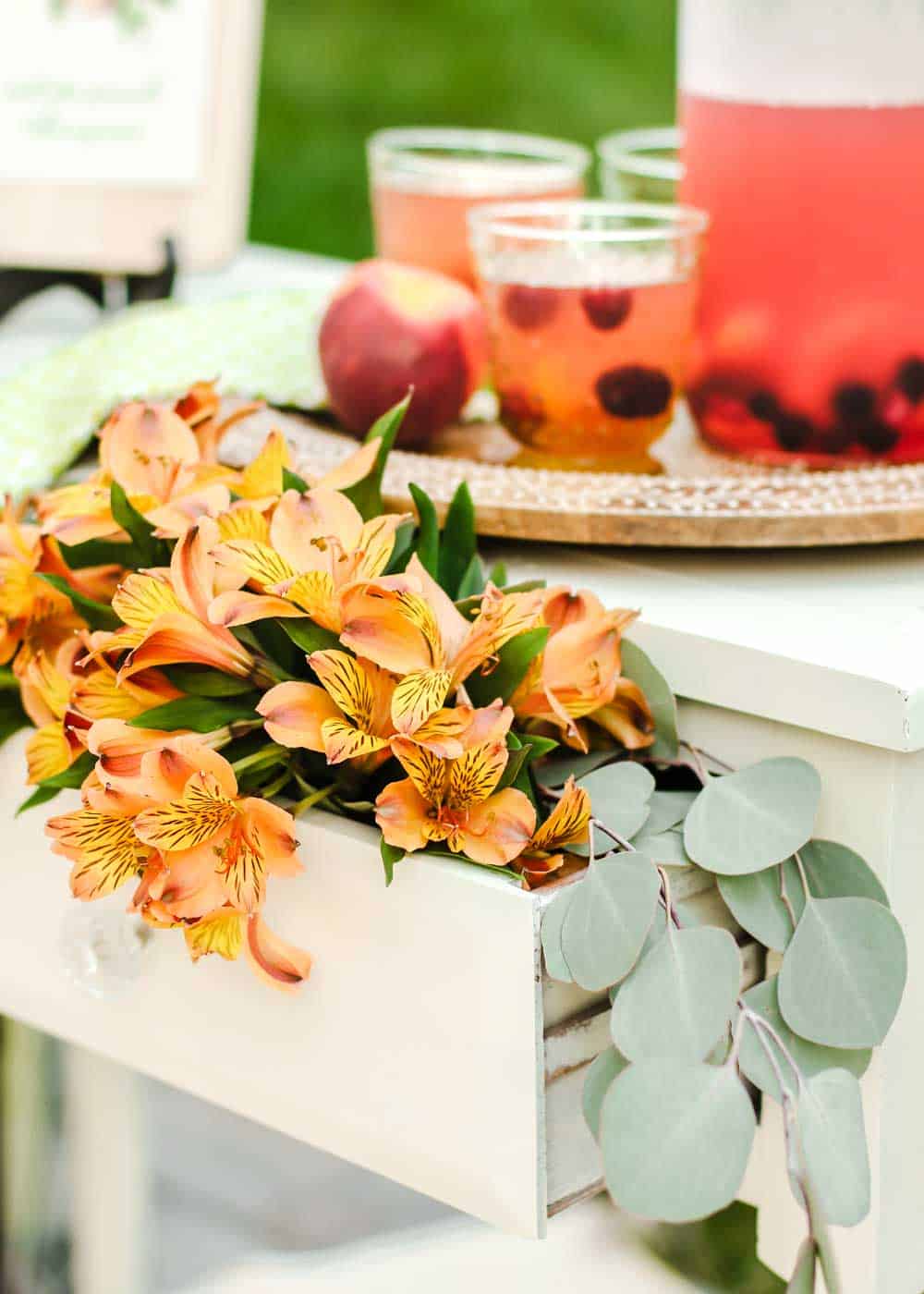 party table with drawer filled with flowers.