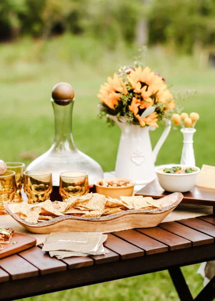 party table with food and drink set up outside.