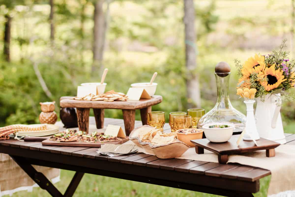 party table with food and drink set up outside.