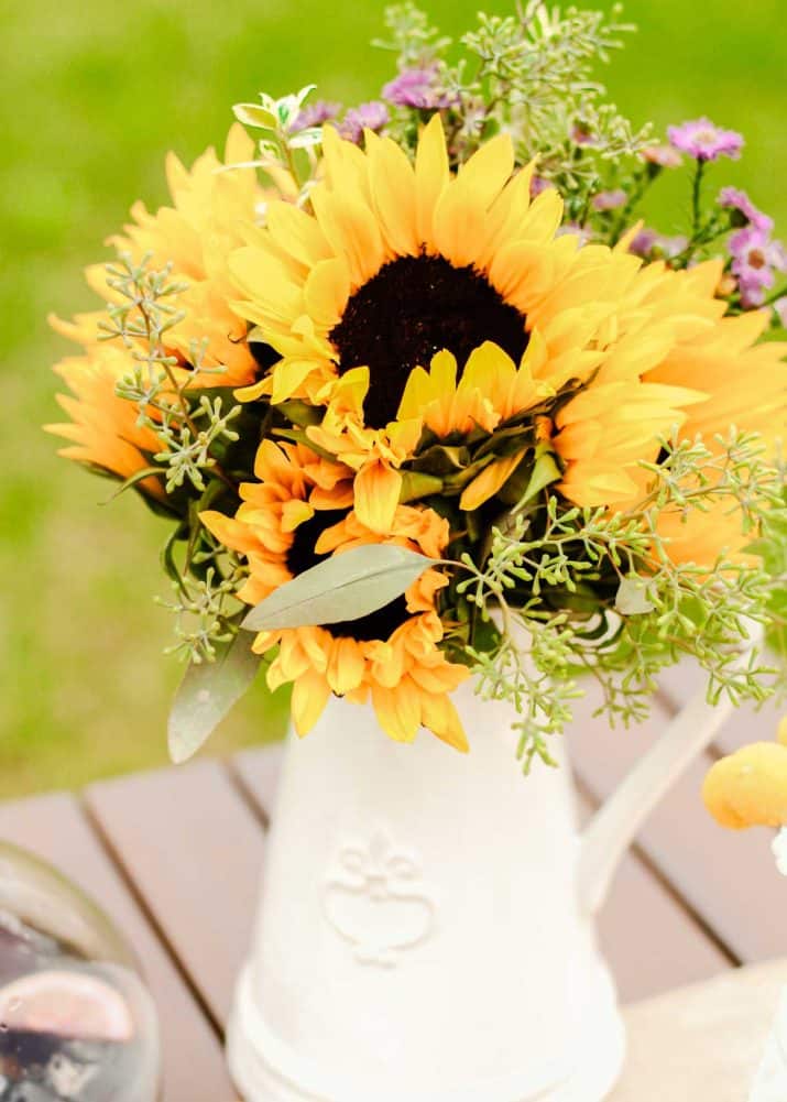 white pitcher with sunflowers centerpiece. 
