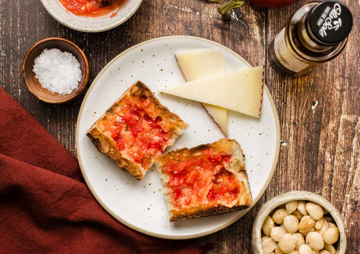 traditional tomato bread on white plate with slice cheese.