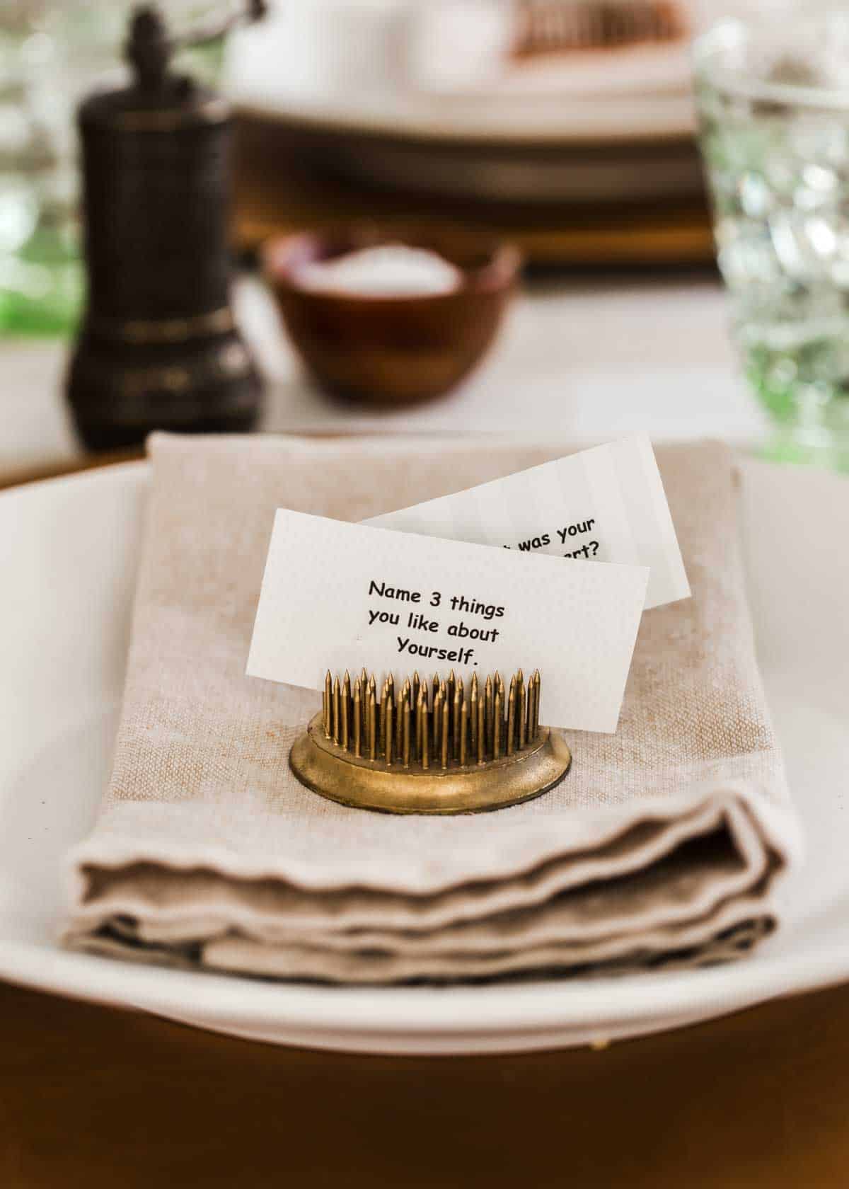 dinner plate with vintage floral frog holding conversation cards.