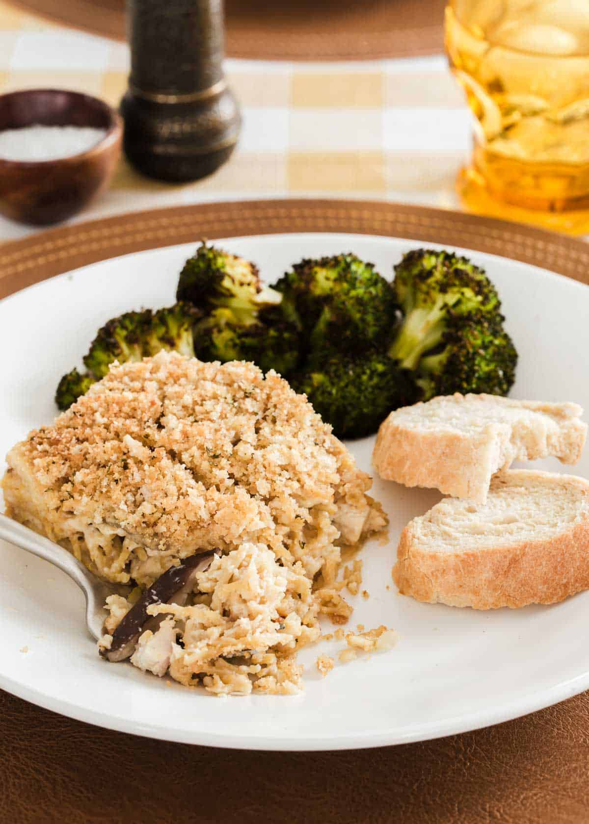 chicken tetrazzini on plate with broccoli and bread.