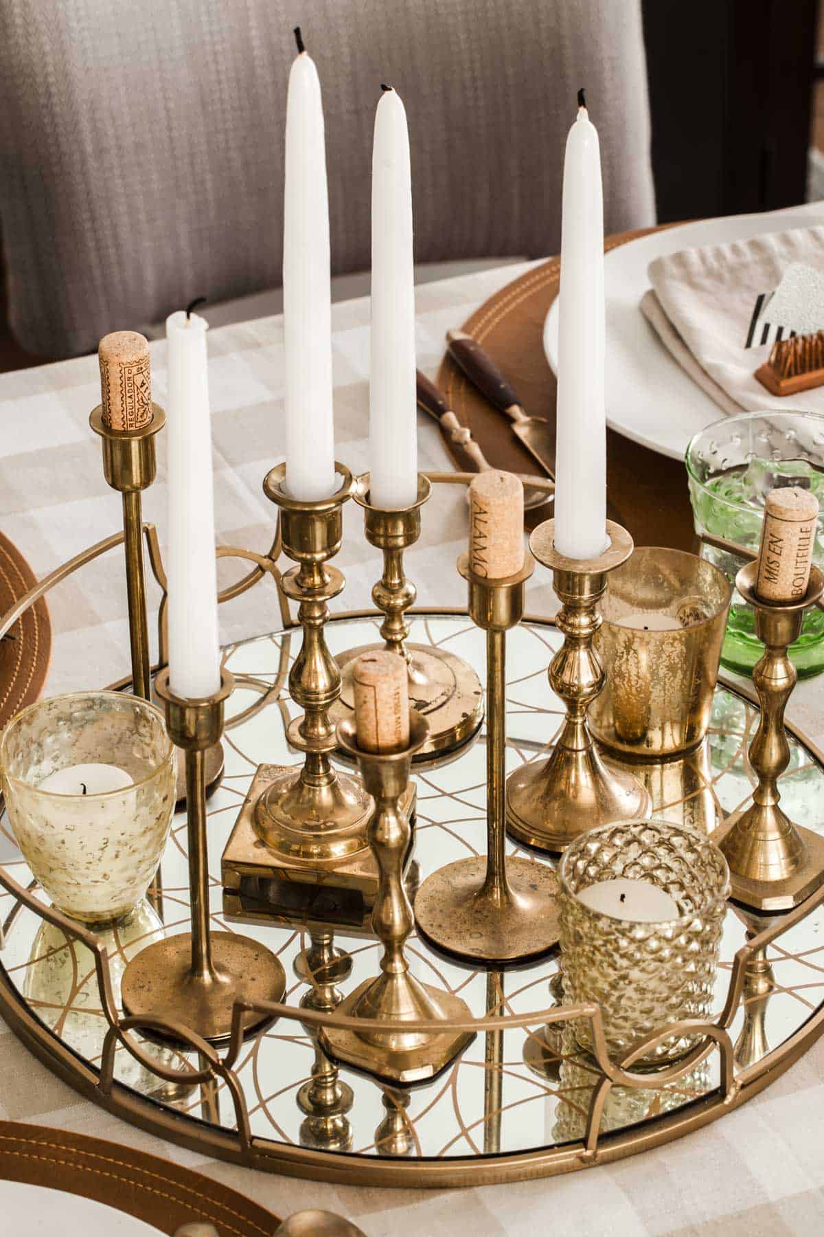 round mirror tray with gold candle sticks for centerpiece.