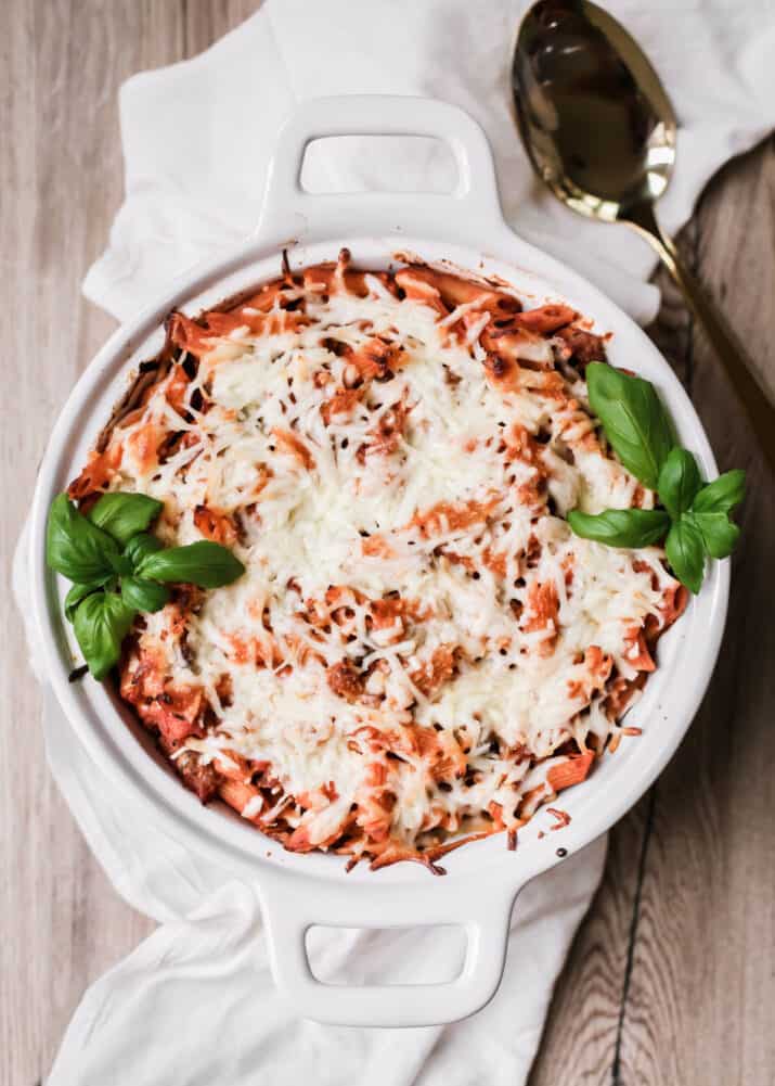 round baking dish with baked pasta and cheese, overhead view.