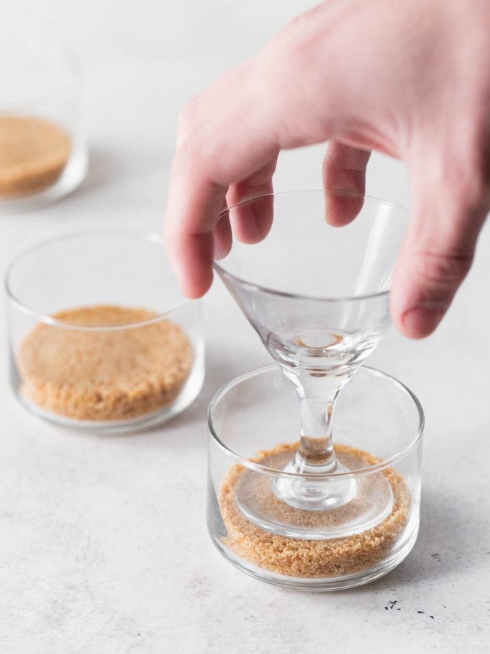 pressing crumb crust into small dessert cup.