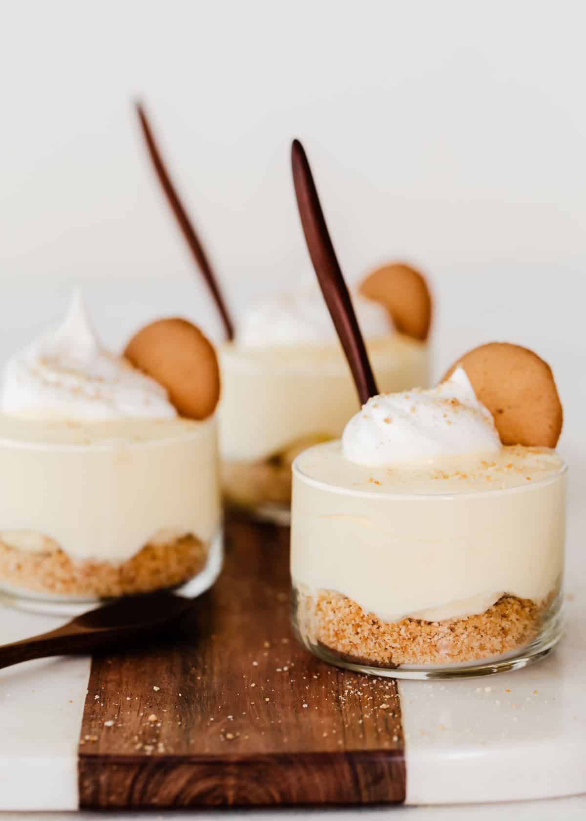 Three individual glass cups with banana pudding.