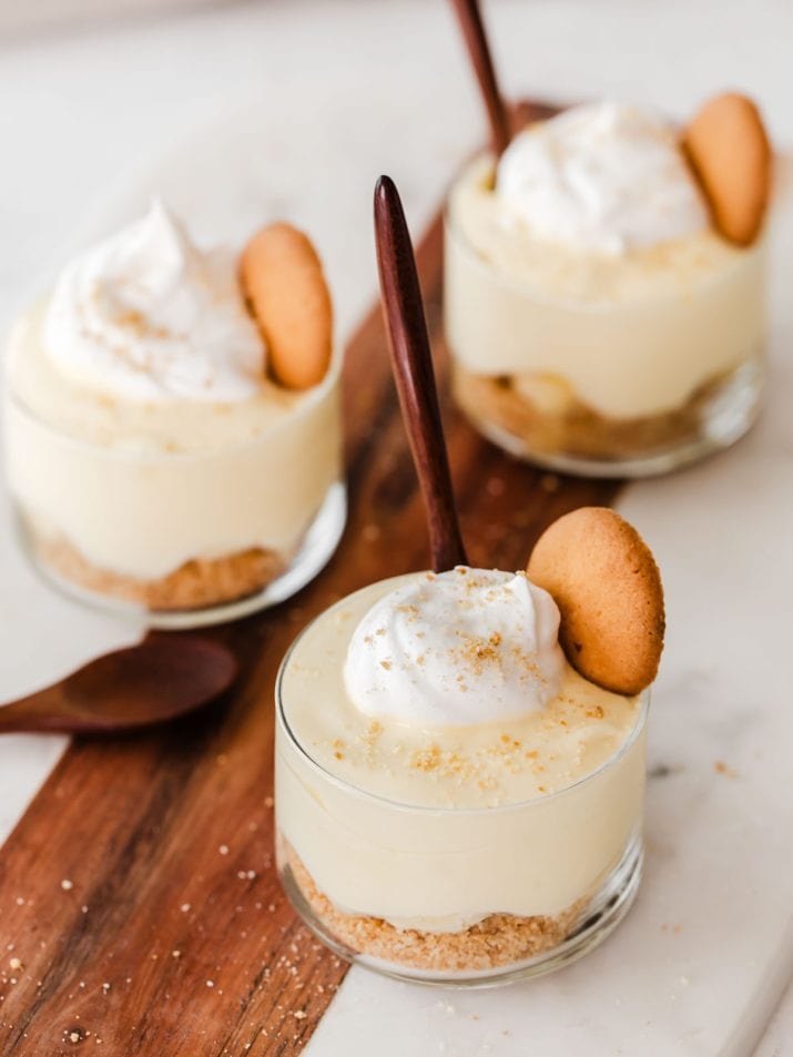 Three individual glass cups with banana pudding.