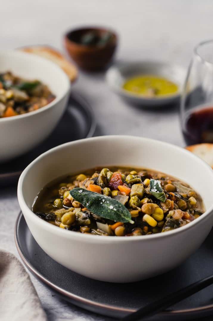 lentil vegetable soup in tan bowl on gray plate