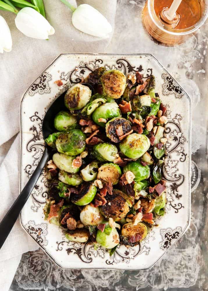 brussels sprouts with bacon and nuts served in vintage dish.