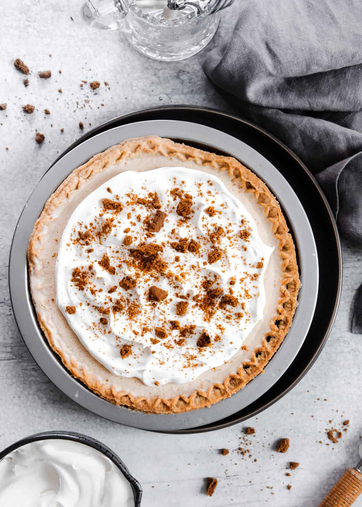 ice cream pie topped with whipped cream and crushed cookies.