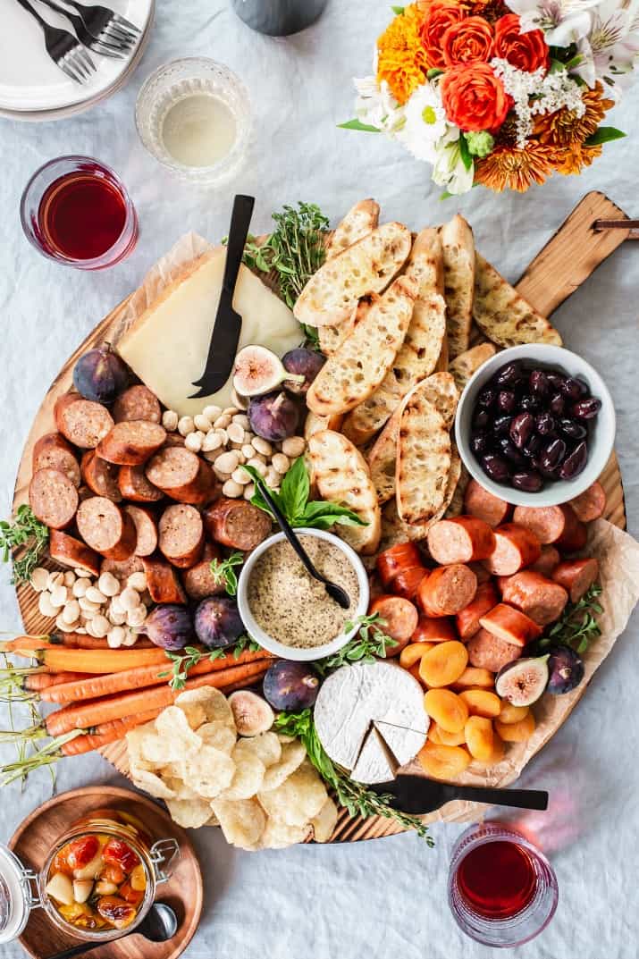 large round cheese and charcuterie board ready for a party