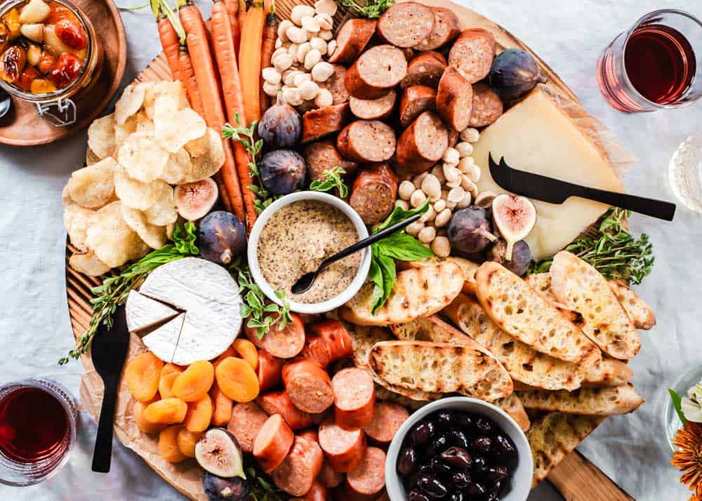 classic charcuterie board with smoke sausage bites, cheese, and accoutrements.