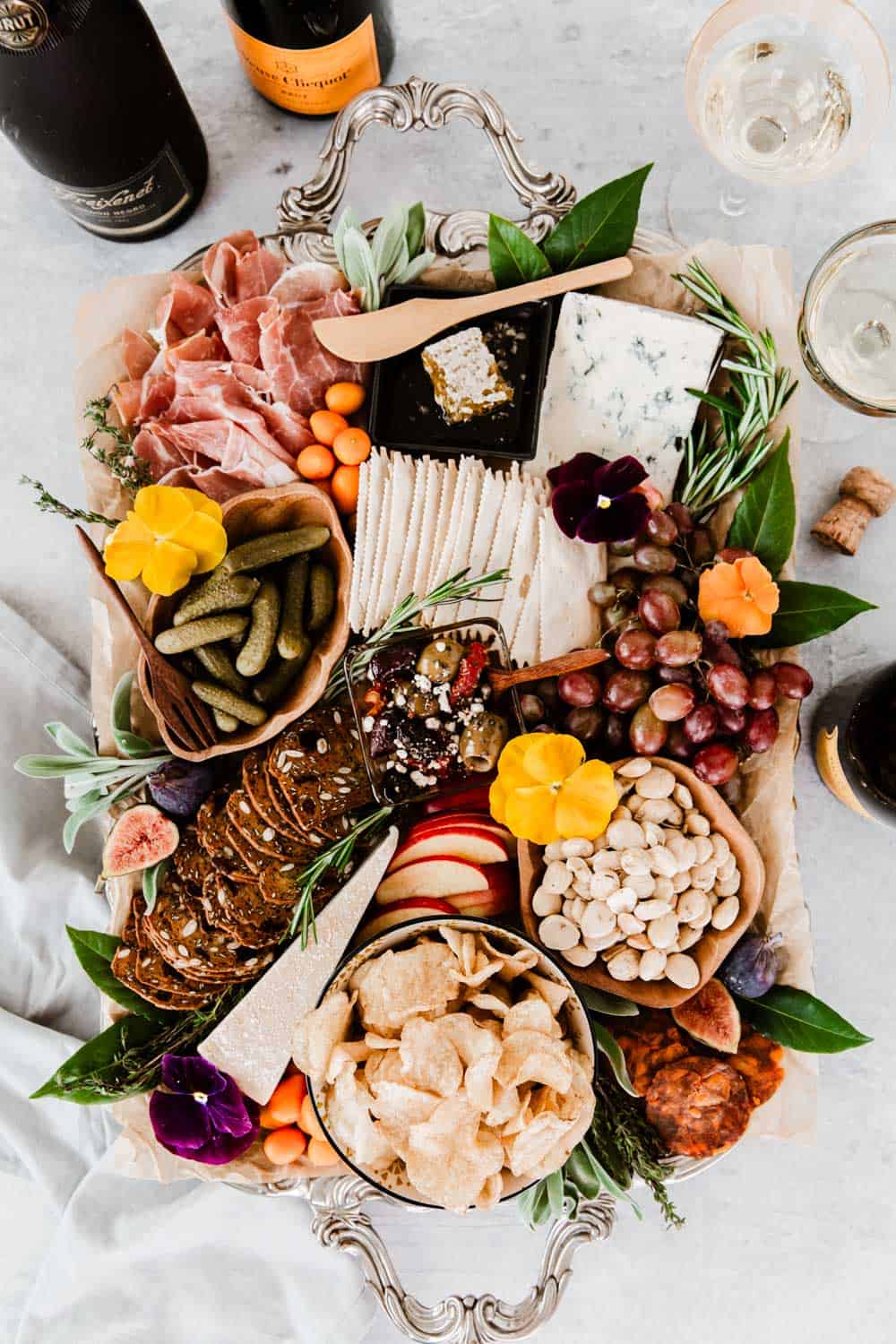 silver tray filled with charcuterie, cheese, and all the fixings.