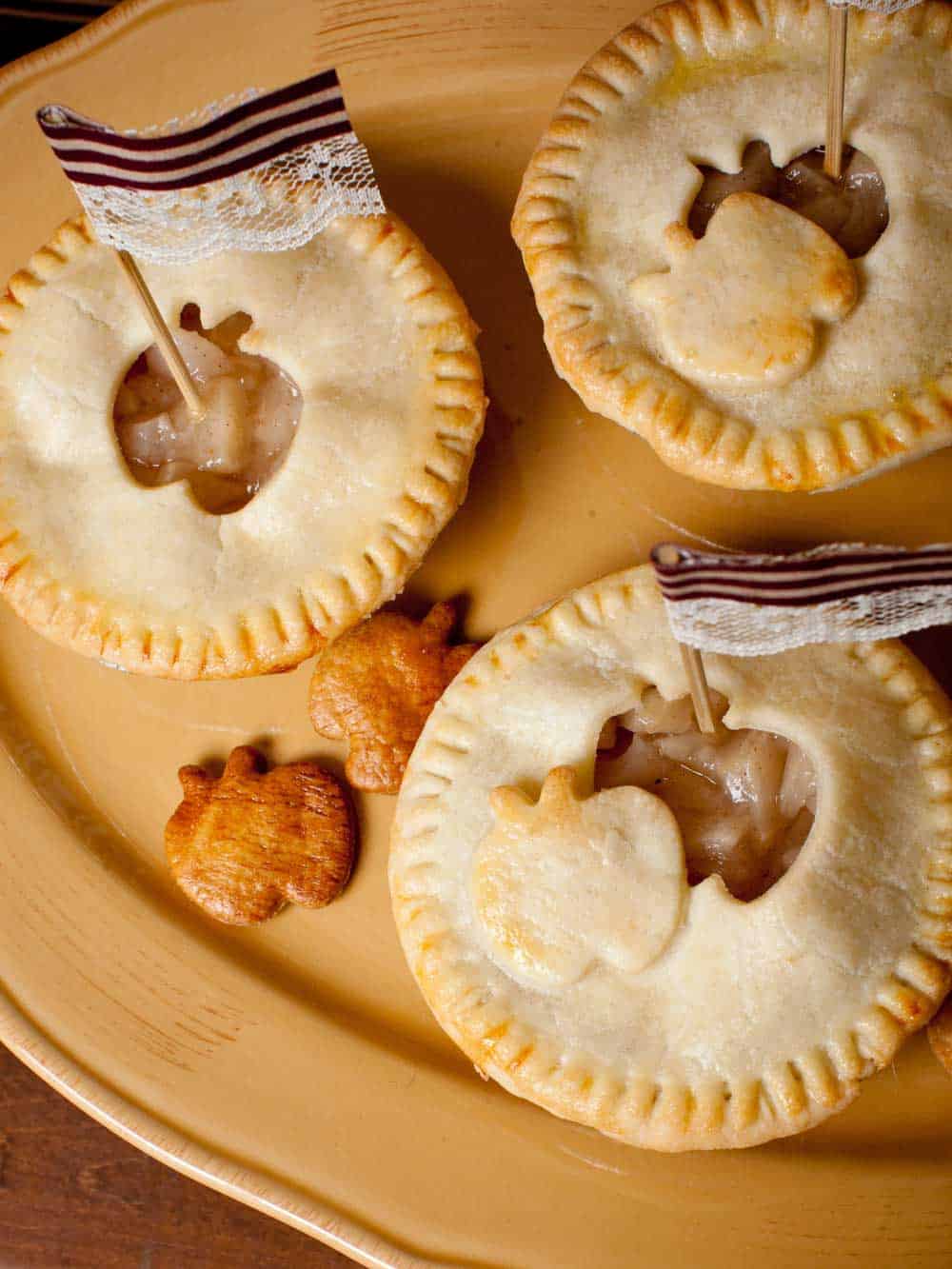 mini apple pies with apple cutouts in the crust.