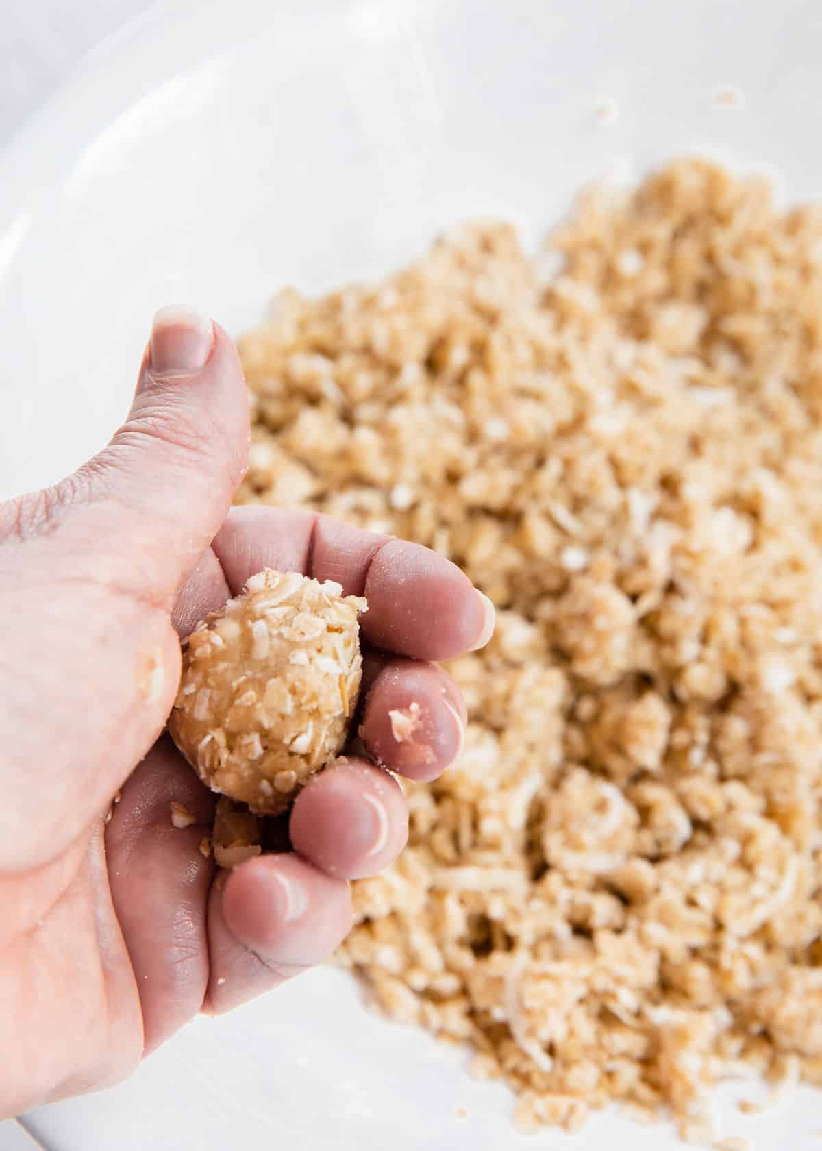 hand forming round cookie dough ball.