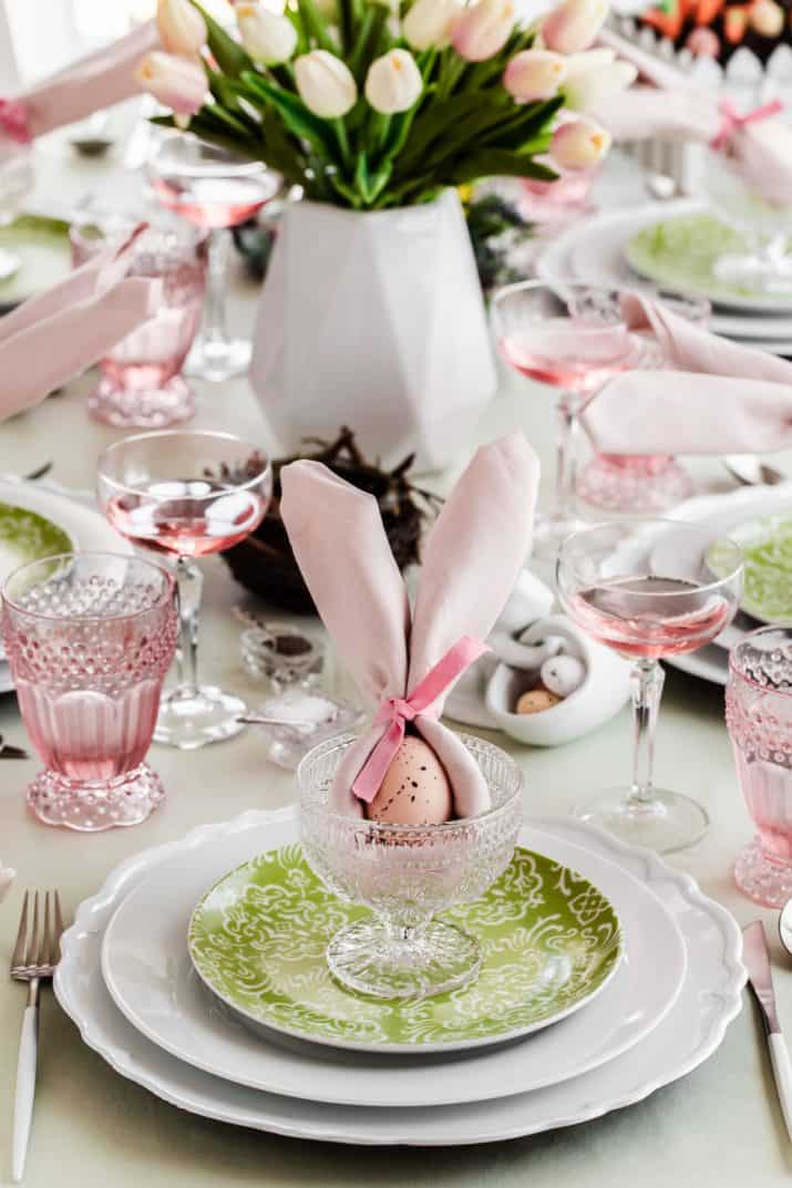 Green plate on white plate with pink napkin bunny ears