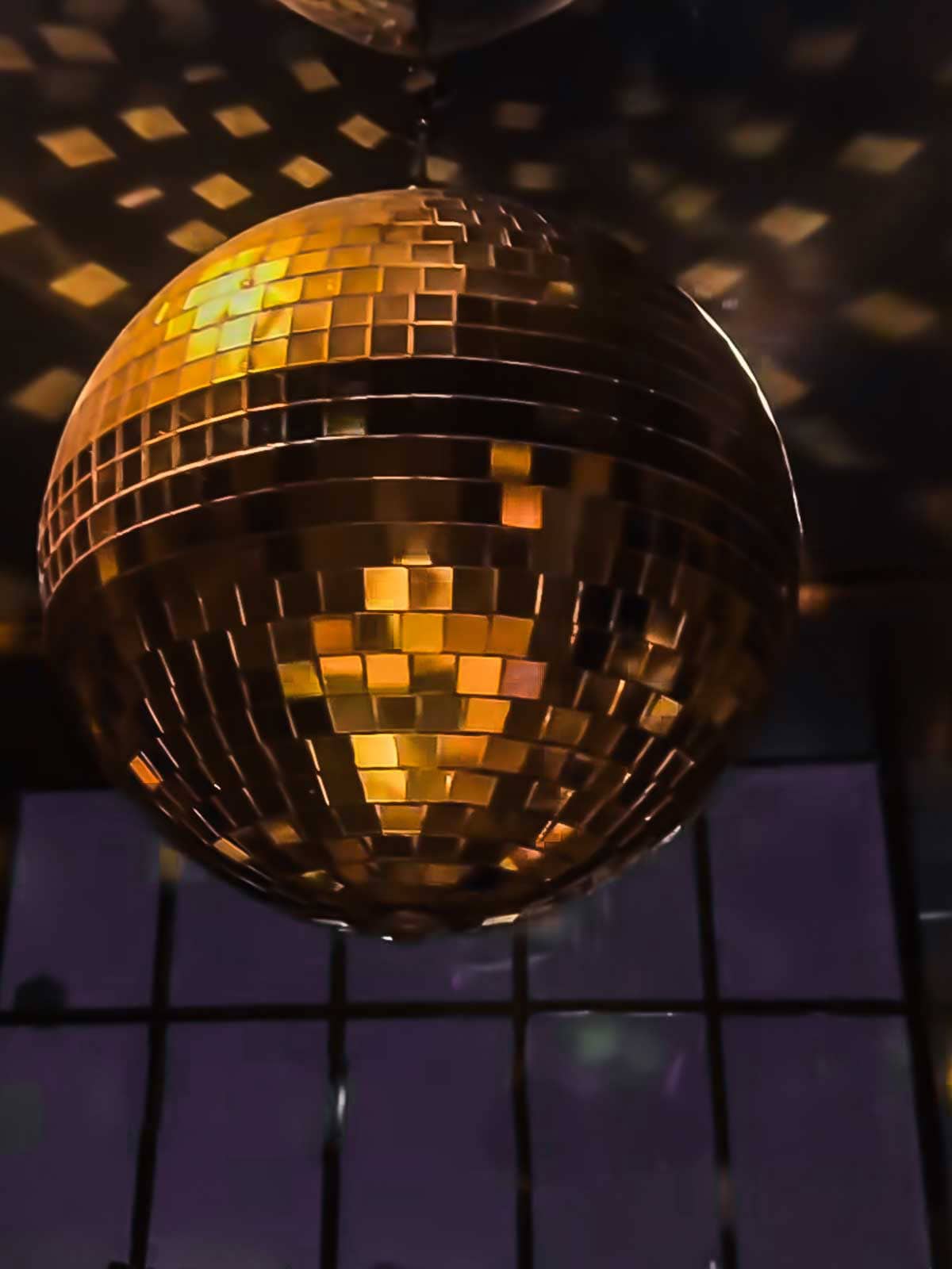 gold disco ball hanging from ceiling. 