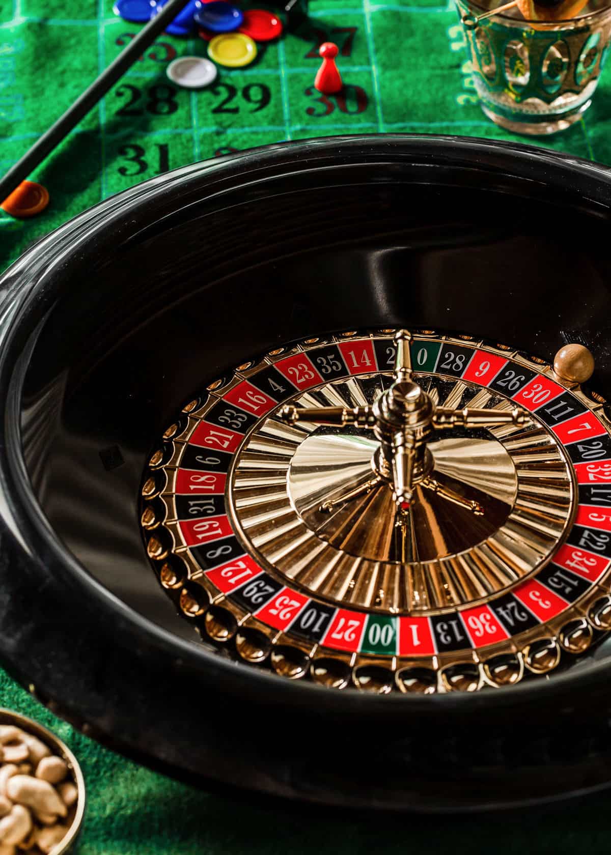 roulette wheel on green craps table.