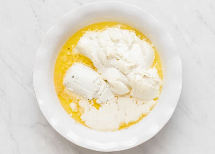 corn dip melted ingredients in white dish.