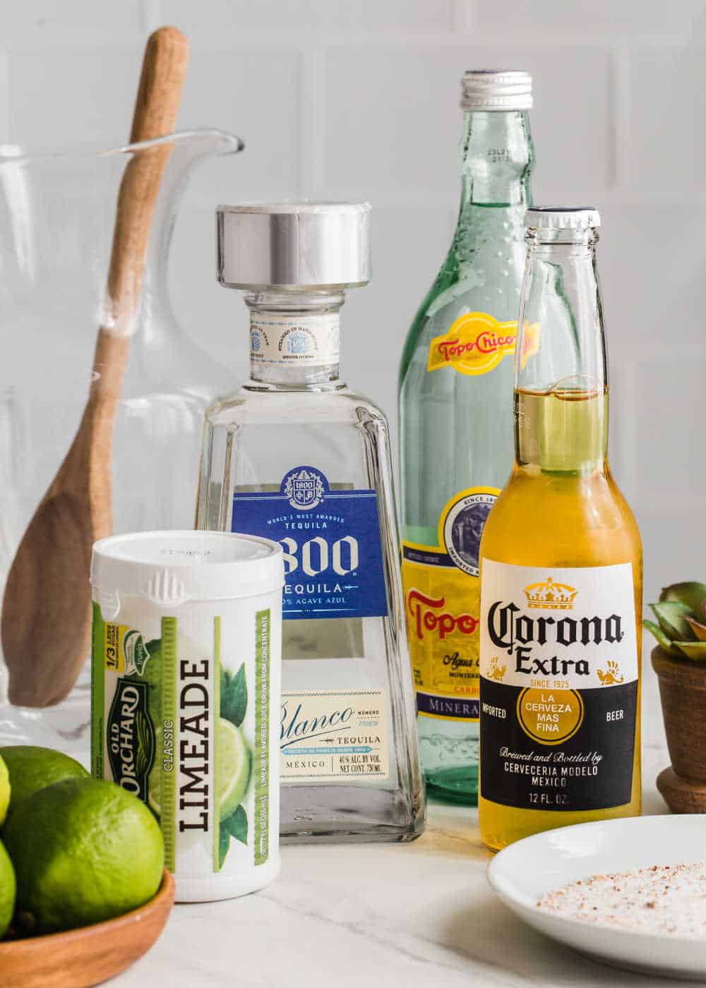 ingredients for beer margarita on white counter with white backsplash.