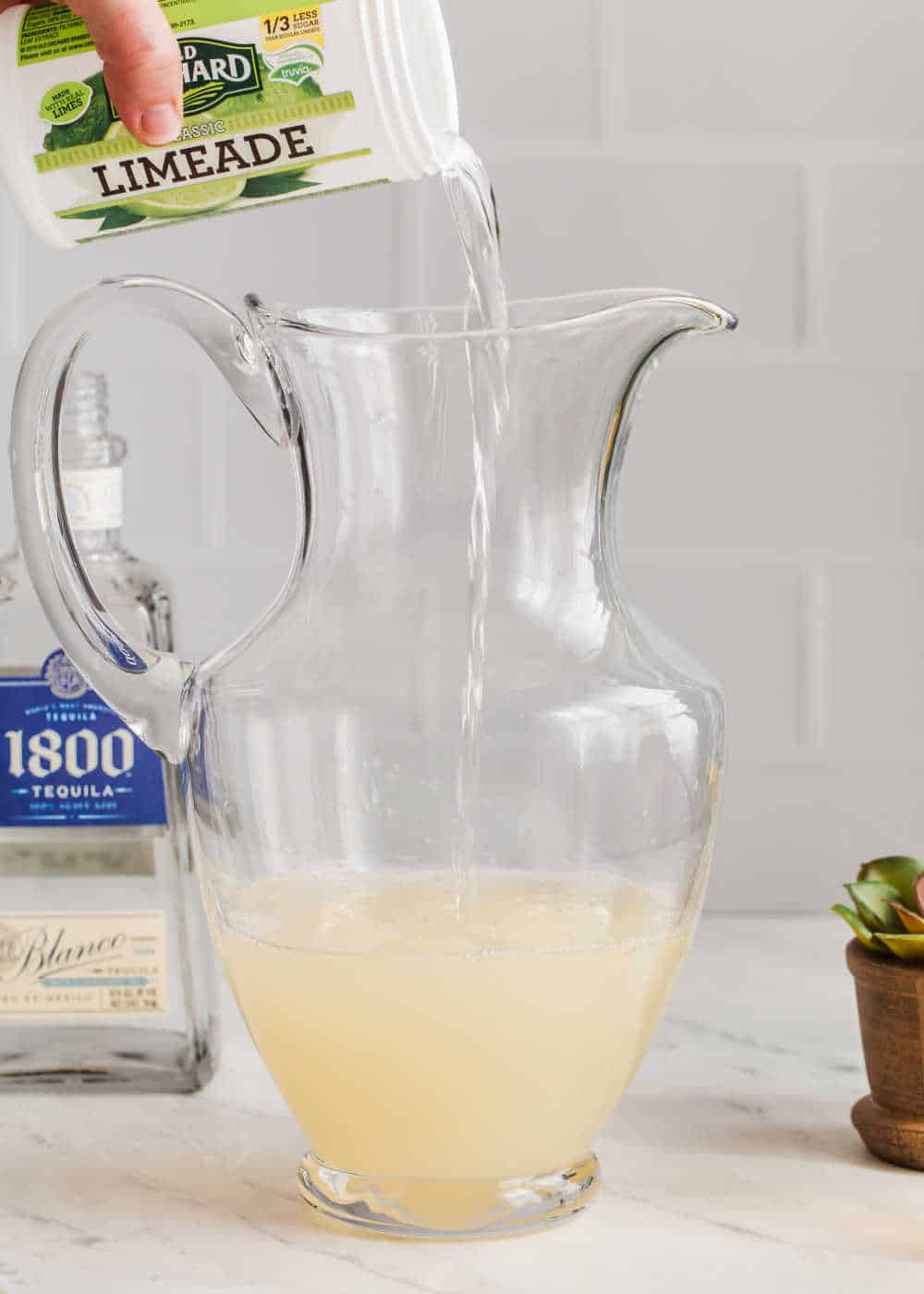 pouring limeade into pitcher.