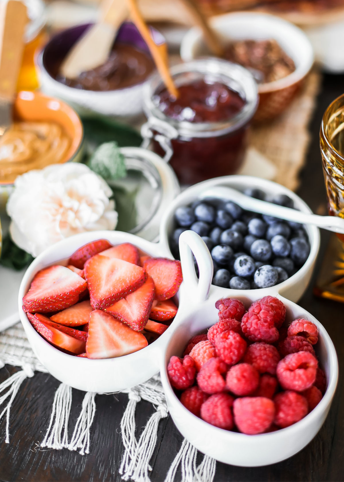 trio of berries in white bowls.