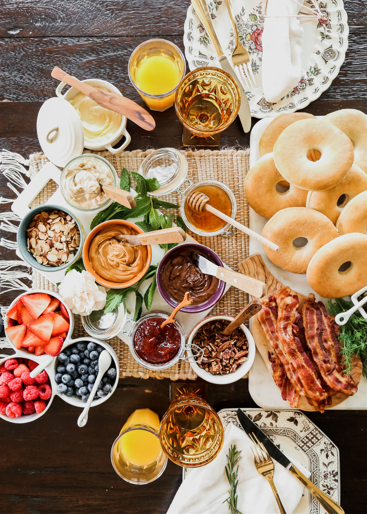 bagel breakfast bar with spreads and toppings in bowls.