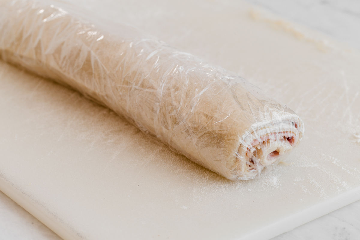 rolled up pastry wrapped in plastic wrap.