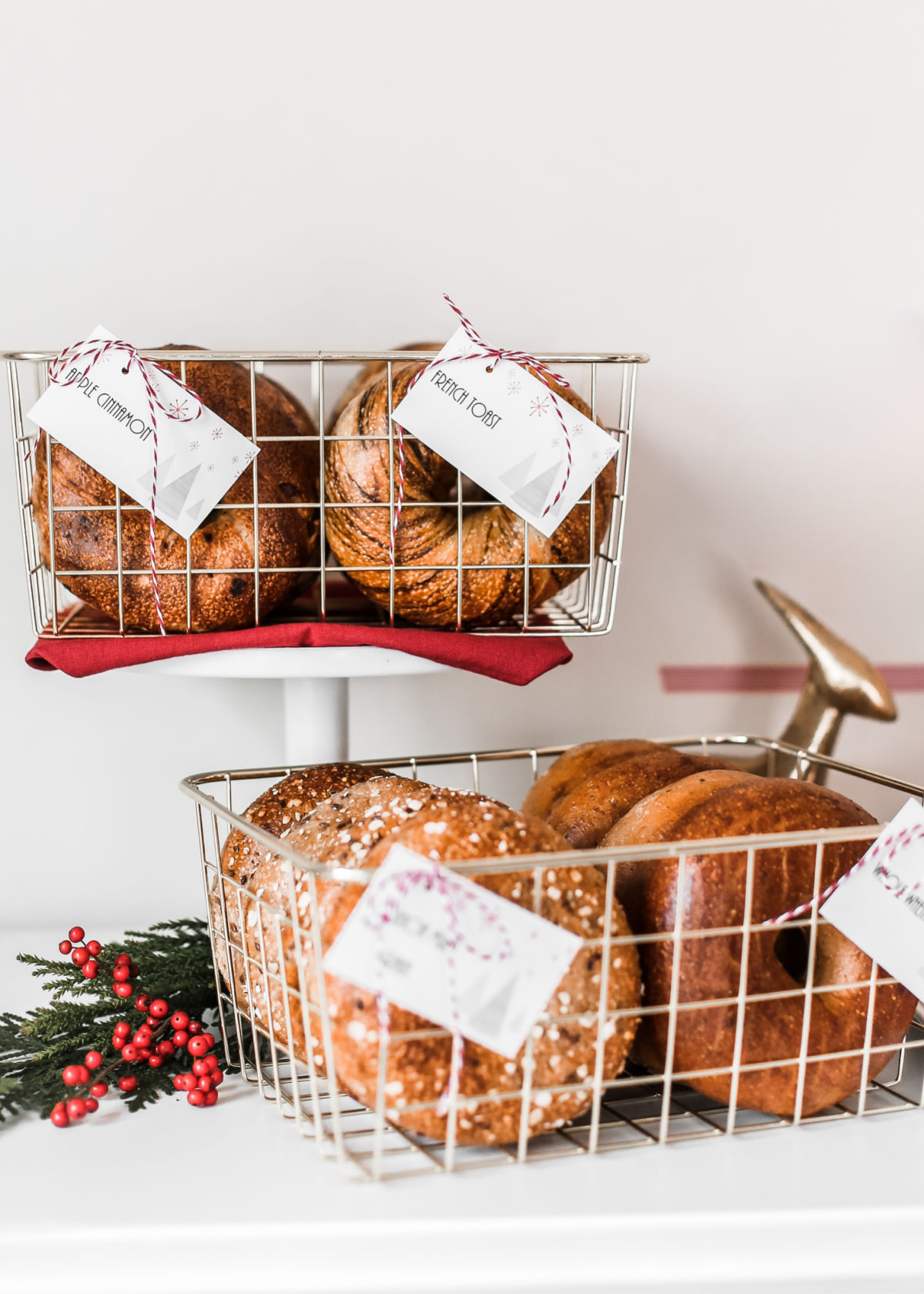 bagels displayed in wire baskets.