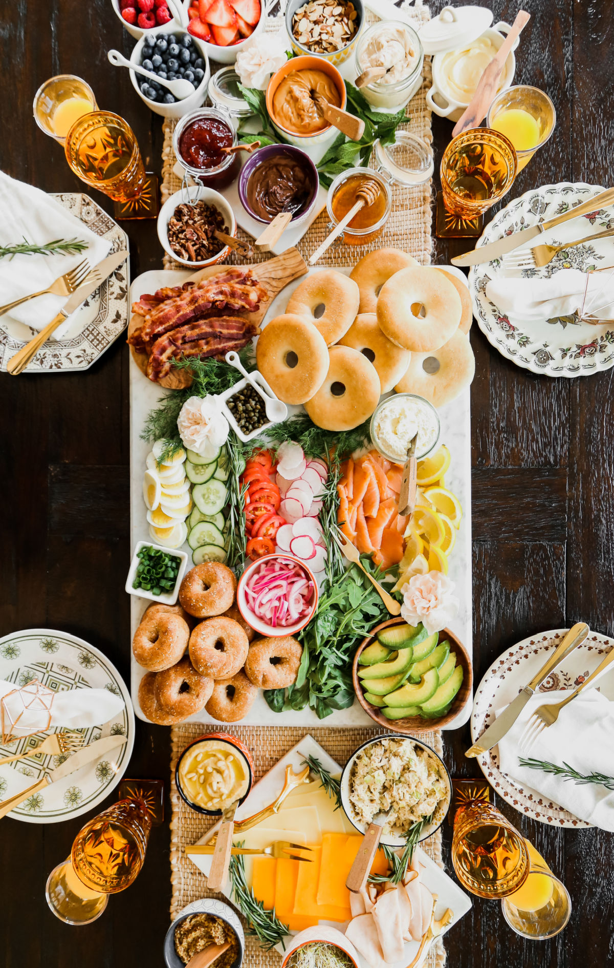 ultimate bagel bar brunch table with lots of sweet and savory toppings.