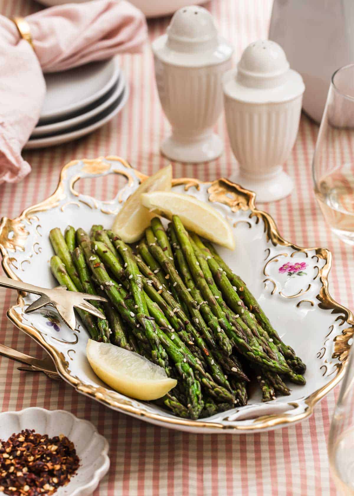 asparagus served on vintage china dish, on spring table setting.