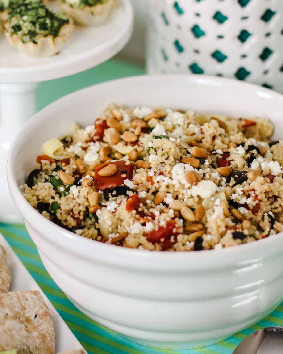 white bowl filled with couscous salad.