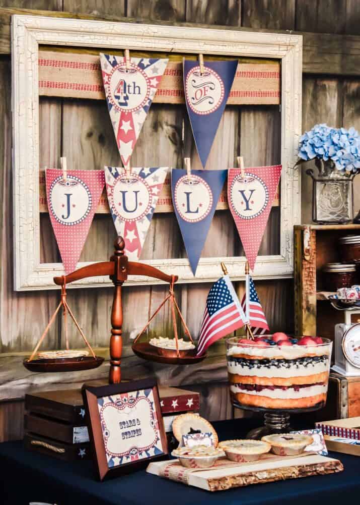 outdoor 4th of July party table with vintage decor and banner.