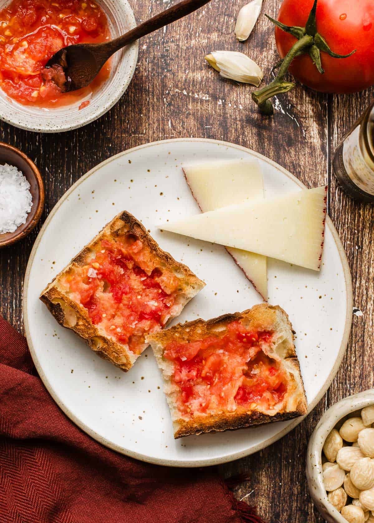 bread slices with tomato spread on top, sitting on plate with cheese slices.