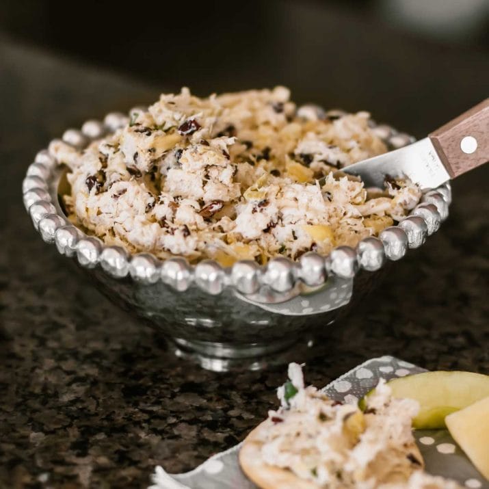 chicken dip in small silver bowl with spreader knife.