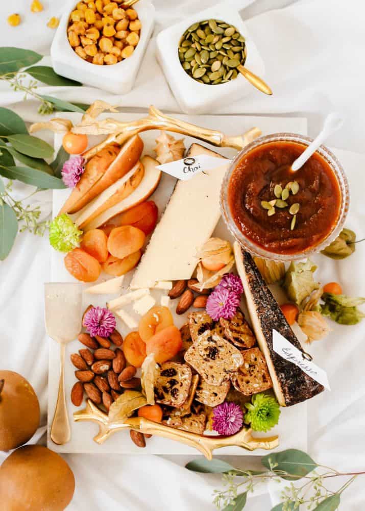 fall-themed small cheese board on white tablecloth.